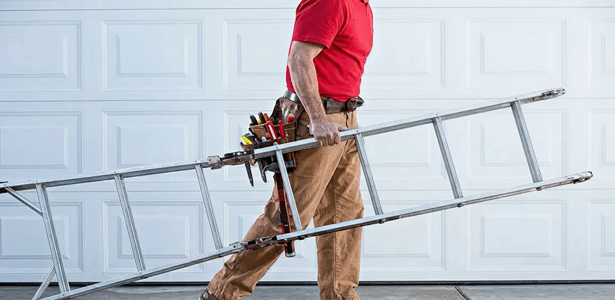 Garage door repair technician arriving with tools and ladder in Rochester, NY
